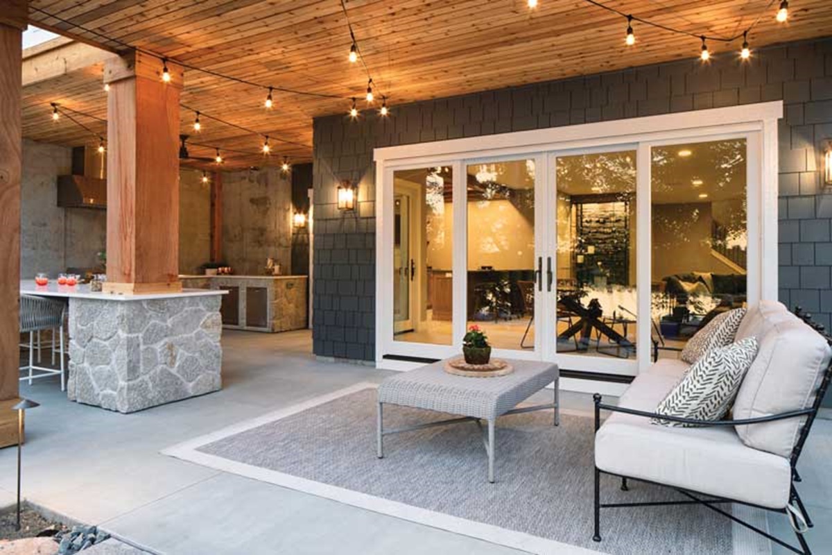 A home’s back patio with patio furniture and large fiberglass patio doors